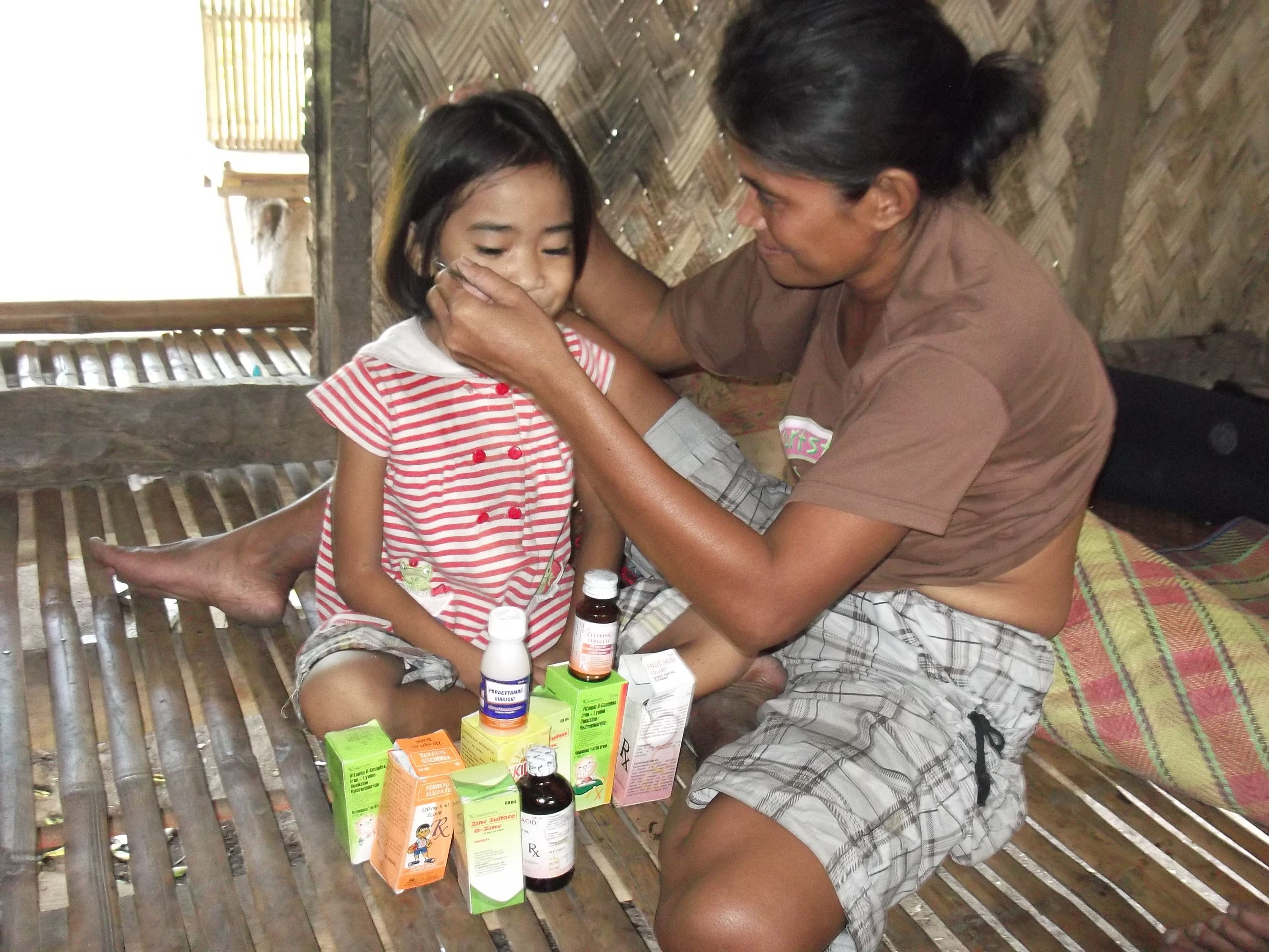 woman-giving-girl-medicine.JPG